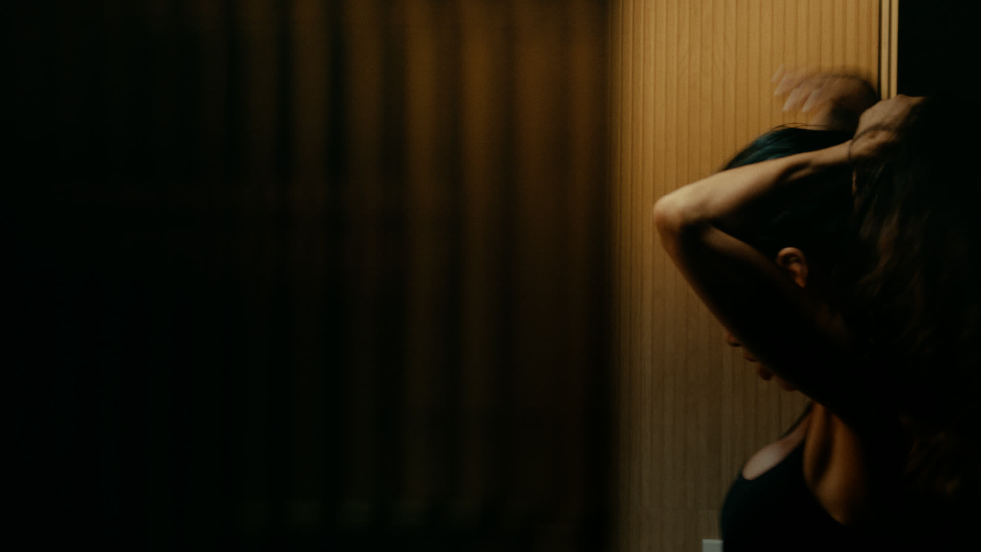 The dimly lit bathroom — still from Nobody Home