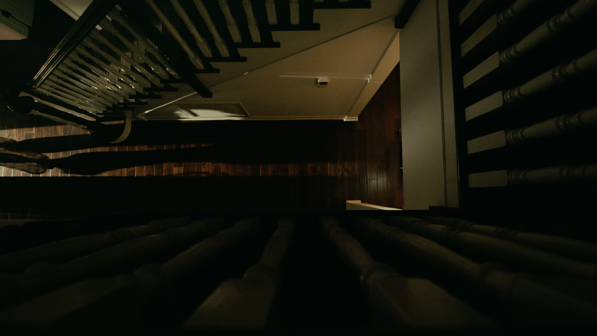 Top-down view of the darkened staircase and entryway — still from Nobody Home