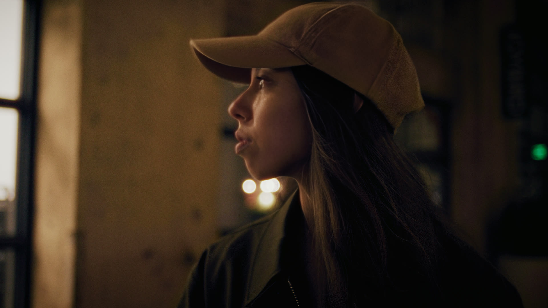 Profile portrait in warm interior light — still from The Row